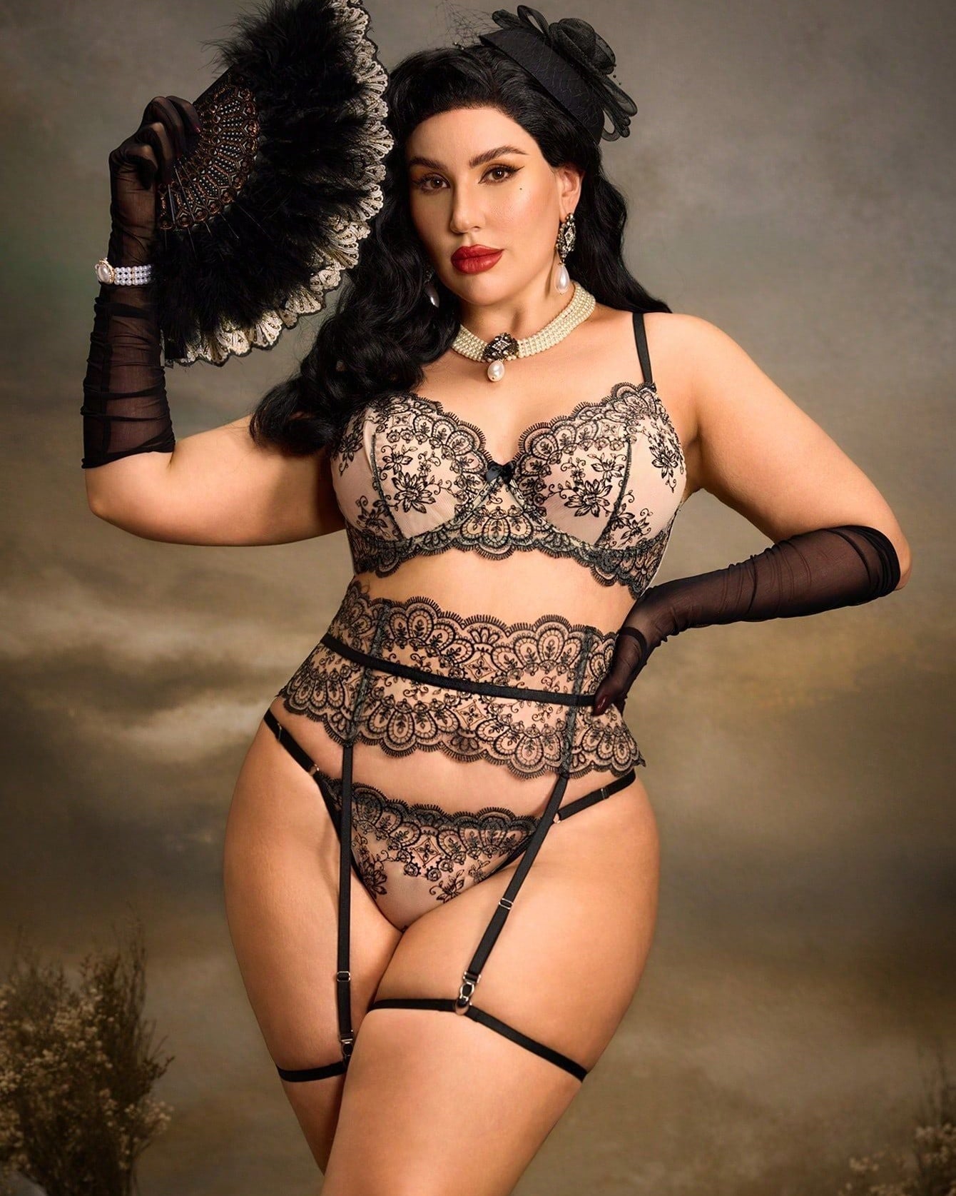 Front view of curvy model wearing black lace set with gloves and fan from the It's Not Complicated Plus Size LingerieSet