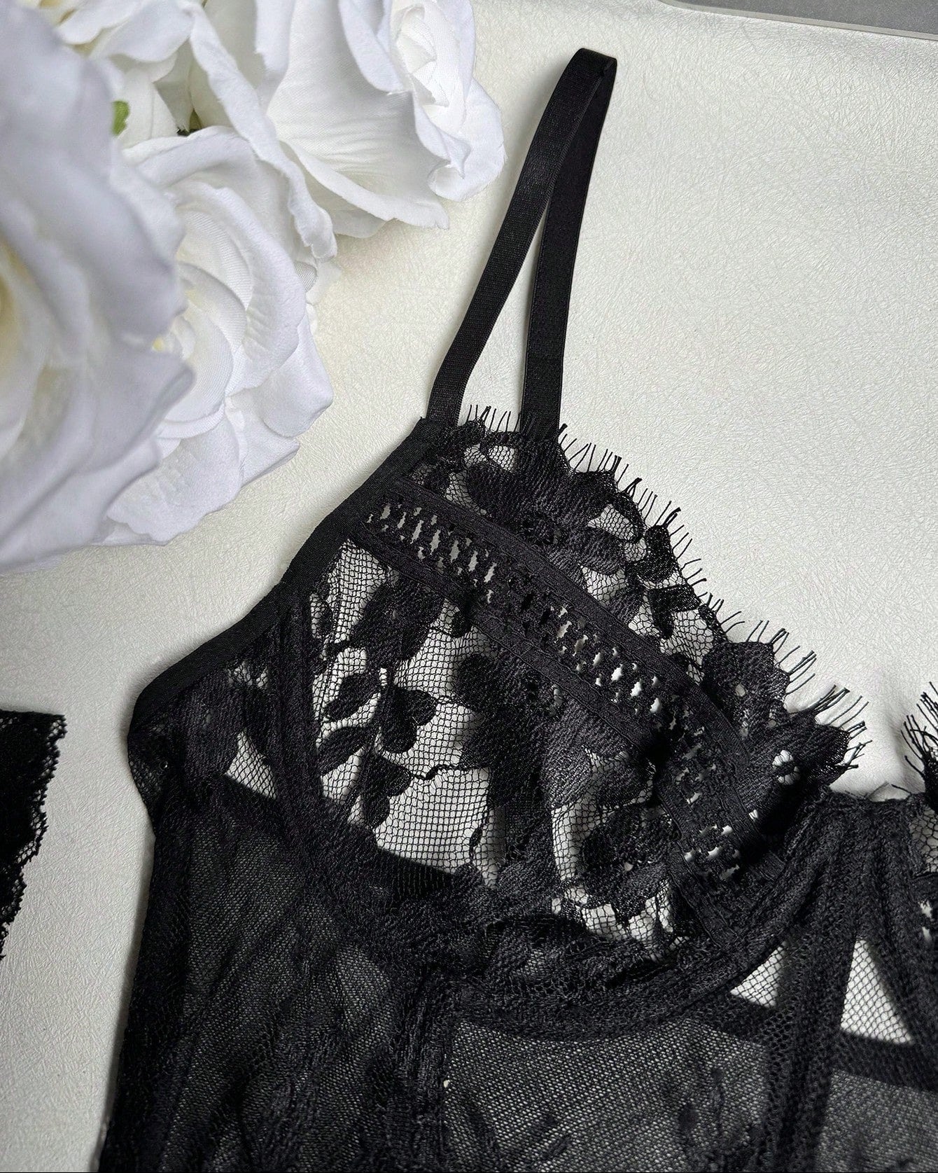 close up of black lace bustier with floral detail