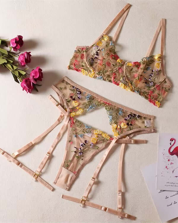 Floral embroidered lingerie set laid flat on a white surface