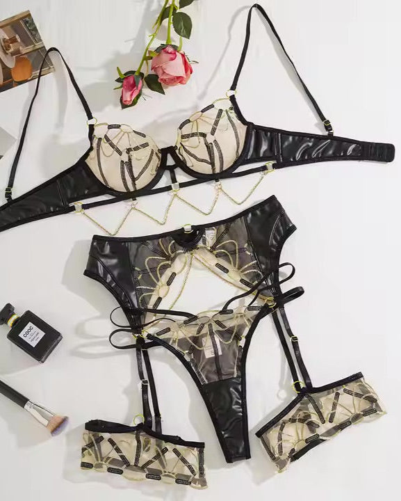 Flat Lay of 5 piece Midnight Reign Gold and Black sexy Lingerie set from The Blackmarket