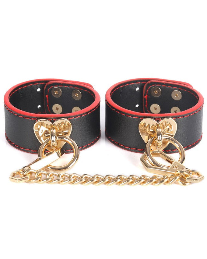 Cuffs with gold details from Obey Me Deluxe BDSM Kit – 10 Piece Red, Black & Gold Boxed Set by the Blackmarket Lingerie