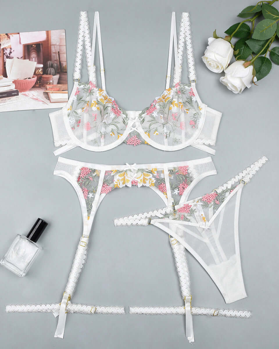 White floral embroidered lingerie set featuring sheer mesh bralette and matching thong from The Blackmarket.
