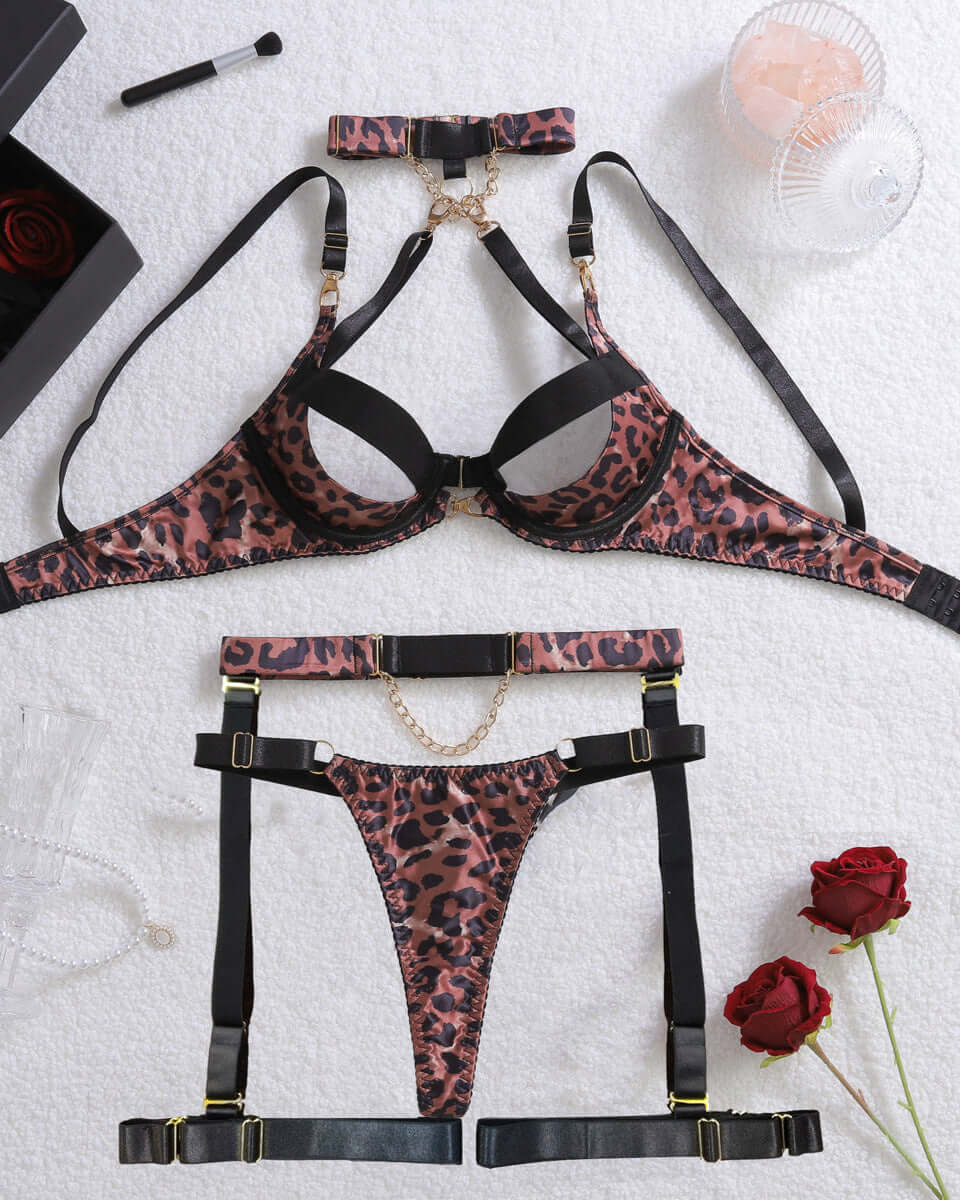 Leopard print lingerie set with garter belt on a textured surface with decorative items.