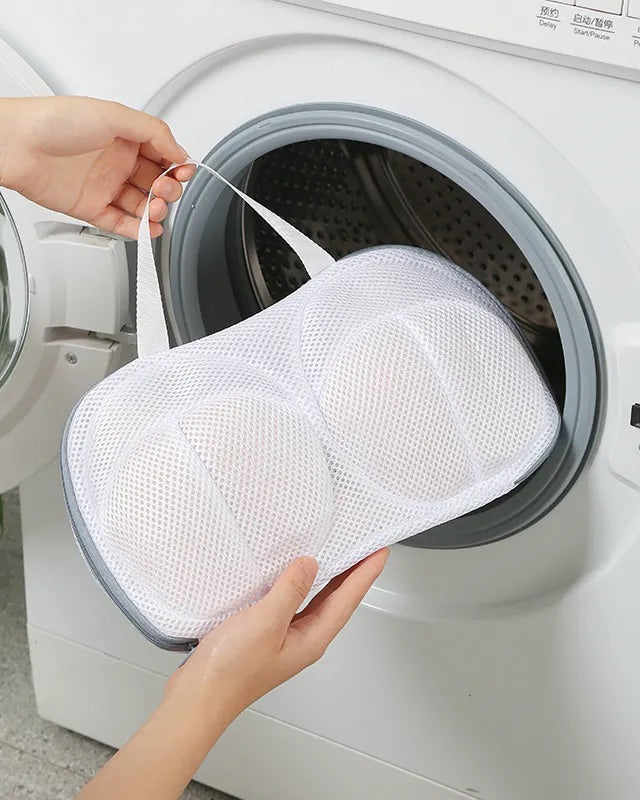 Image of The Blackmarket Lingerie Wash Bag being placed in a front loading washing machine