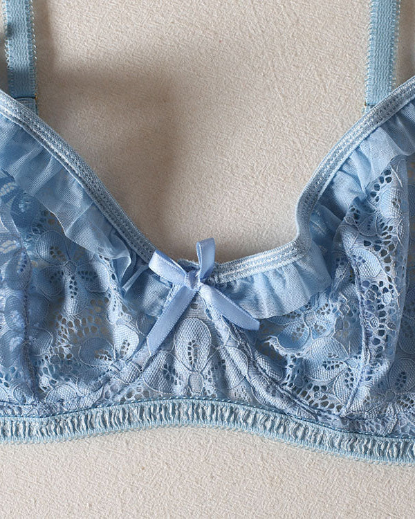 Close-up detail of Make a Wish blue lace underwired bra with floral lace and bow accents